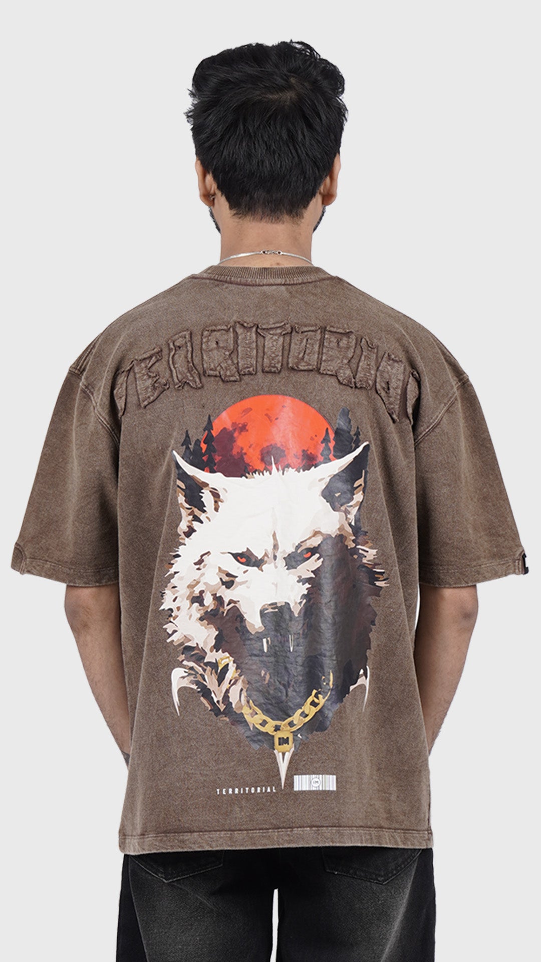 Brown graphic t-shirt with a large wolf back print and Territorial text