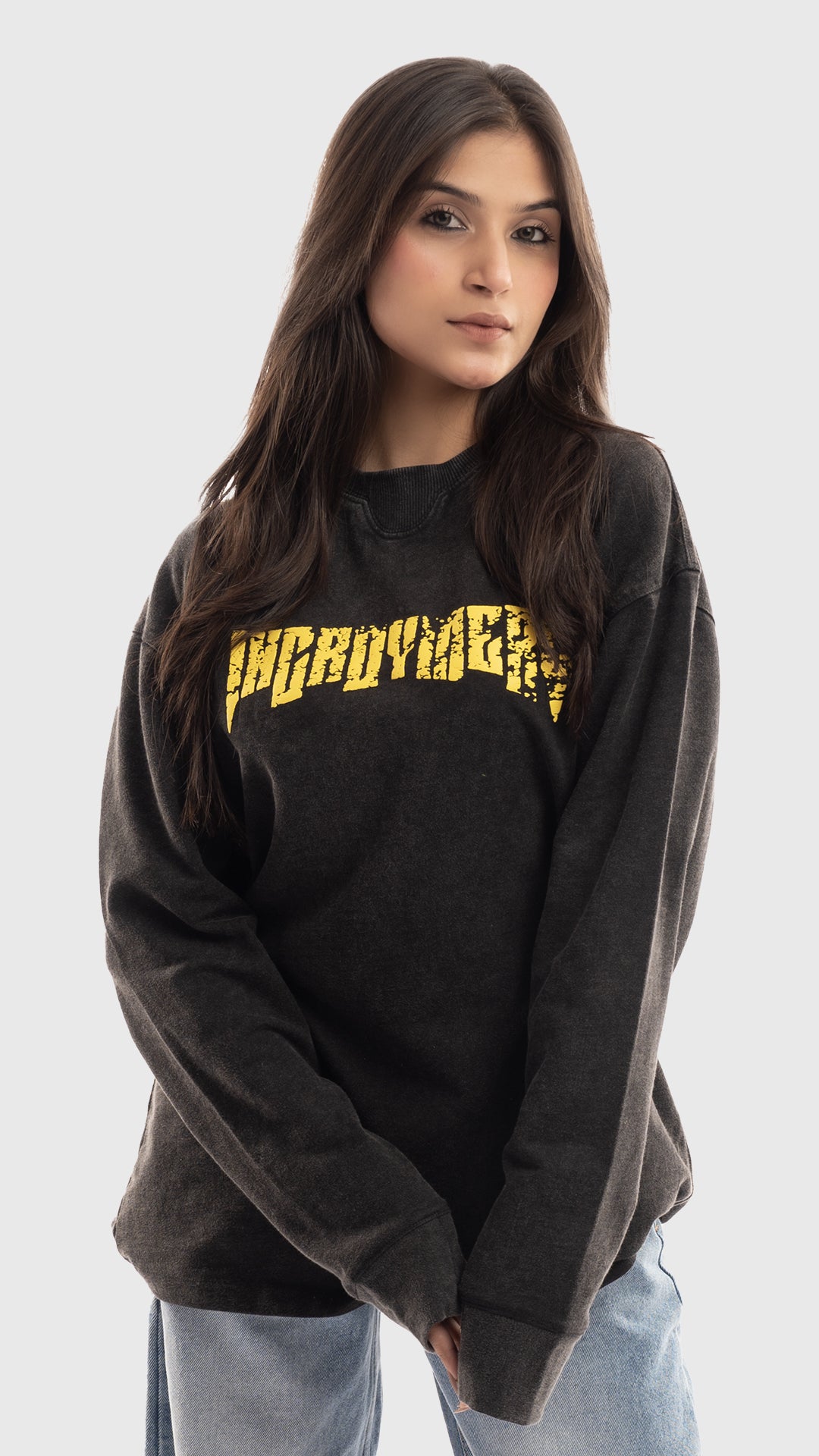 Front view of a women's charcoal grey oversized sweatshirt with yellow graphic text.