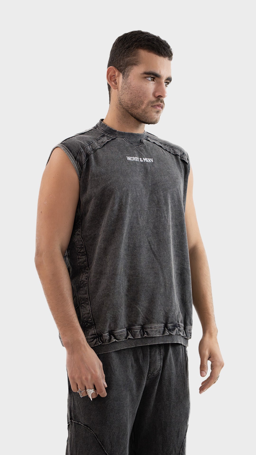Three quarter angle view of the Incroy and Merv Charcoal Beyond Tank Top highlighting the relaxed fit.