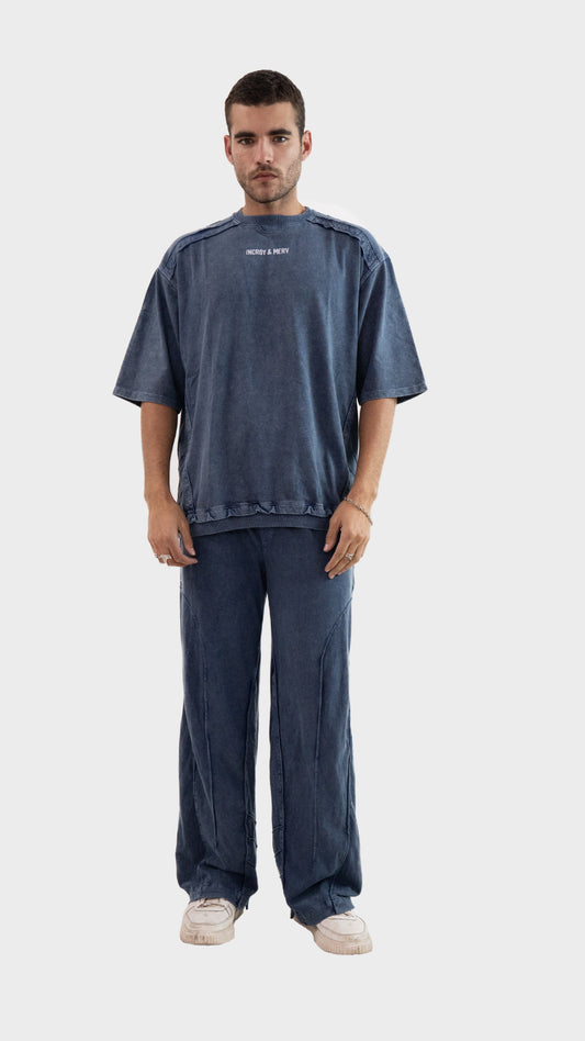 Front view of a man wearing the Incroy and Merv Beyond Co-Ord Set in Dusky Blue featuring an oversized t-shirt and matching trousers.
