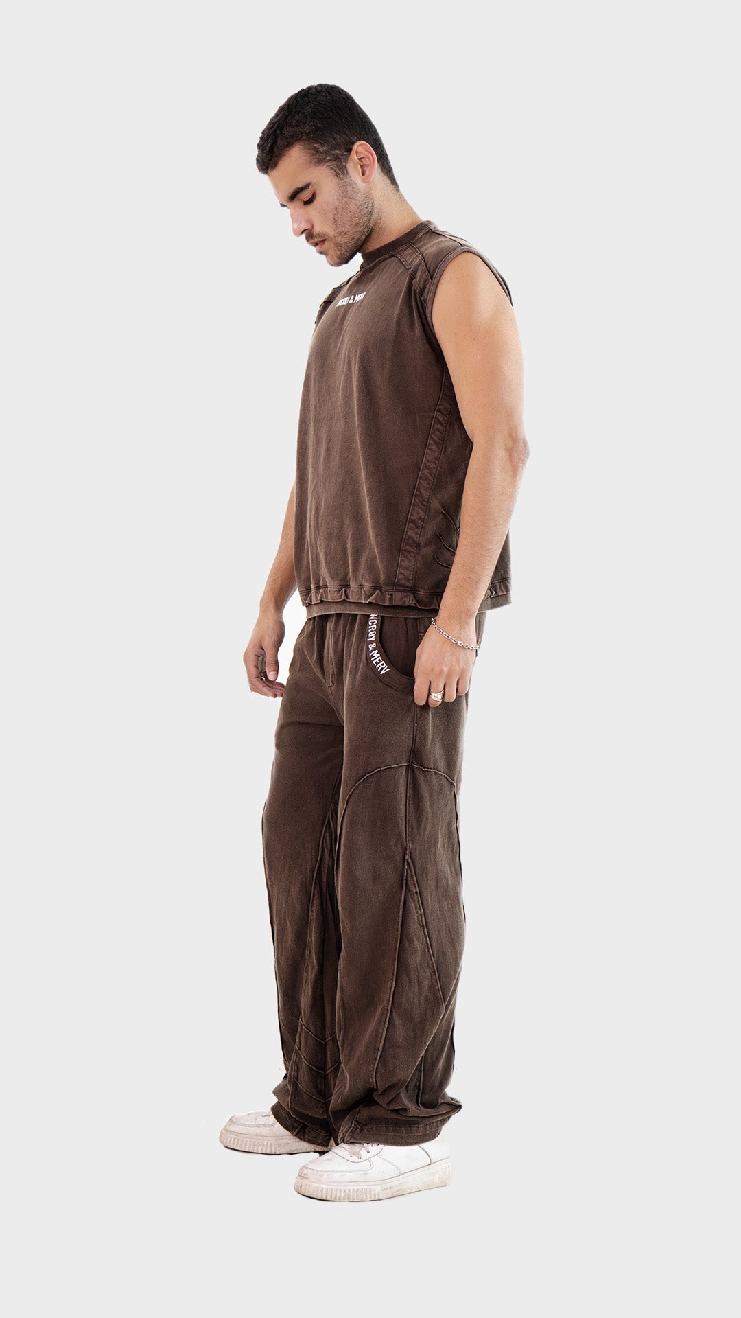 Posed side-angle view of the Incroy and Merv Beyond Tank Top Co-Ord Set in Brown made from sinker cotton fabric.