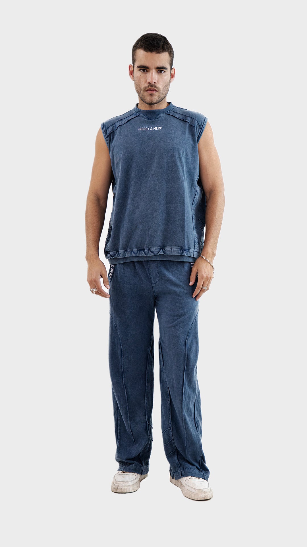 Full body shot of a model wearing the sleeveless Incroy and Merv Beyond Tank Top in Dusky Blue with matching lowers set.
