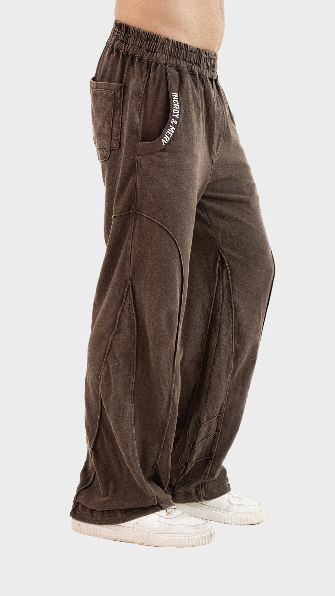 Three-quarter front angle view of Incroy & Merv men's Beyond Trouser in brown displaying pocket typography embroidery.