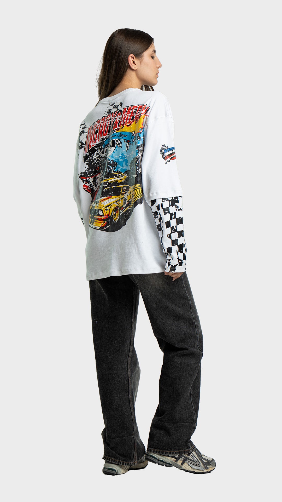 Back view of Incroy & Merv oversized racing graphic tee paired with black baggy jeans.