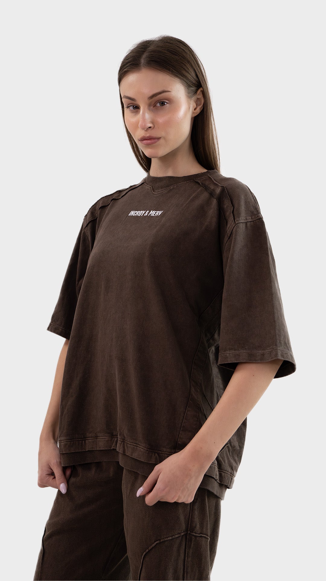 Three-quarter front angle view of a model posing in the brown Beyond T-Shirt in cotton sinker fabric.