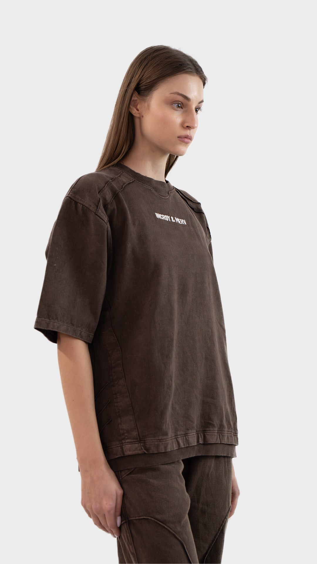 Side profile view highlighting sleeve cut and side seam stitching on the Incroy & Merv women's brown Beyond T-Shirt.