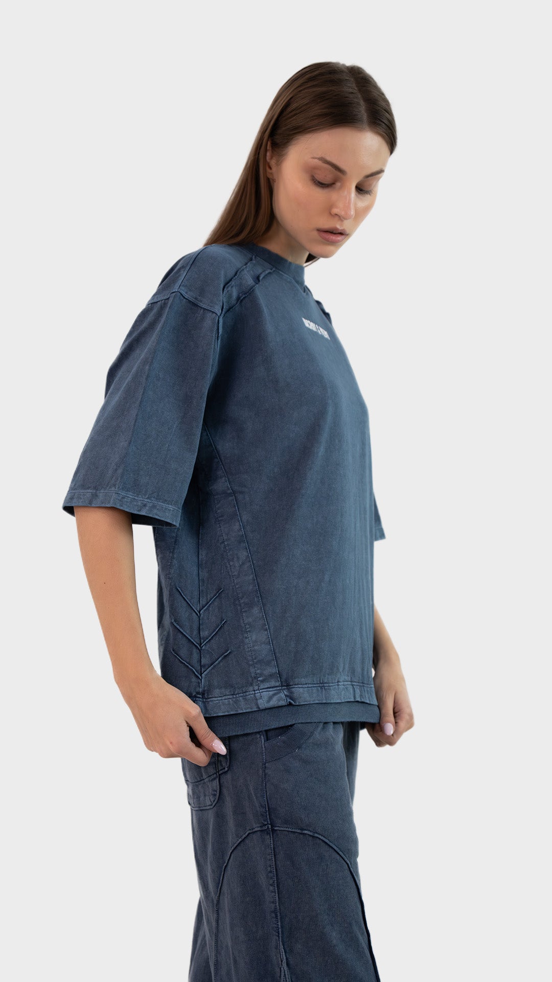 Side view showing side stitching and half sleeves on the Incroy & Merv women's Beyond T-Shirt in dusky blue.