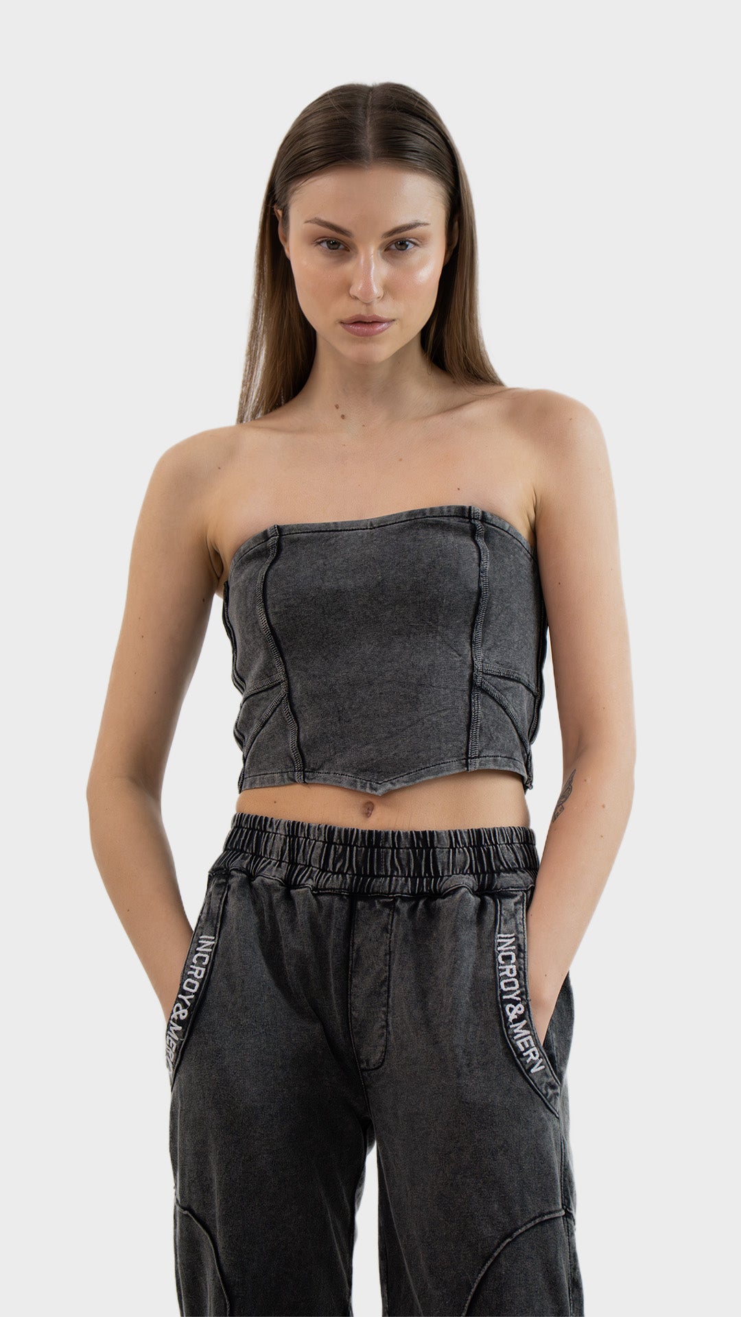 Front view of Incroy & Merv women's Beyond Tube Top in washed charcoal ribbed fabric with corset seam lines.
