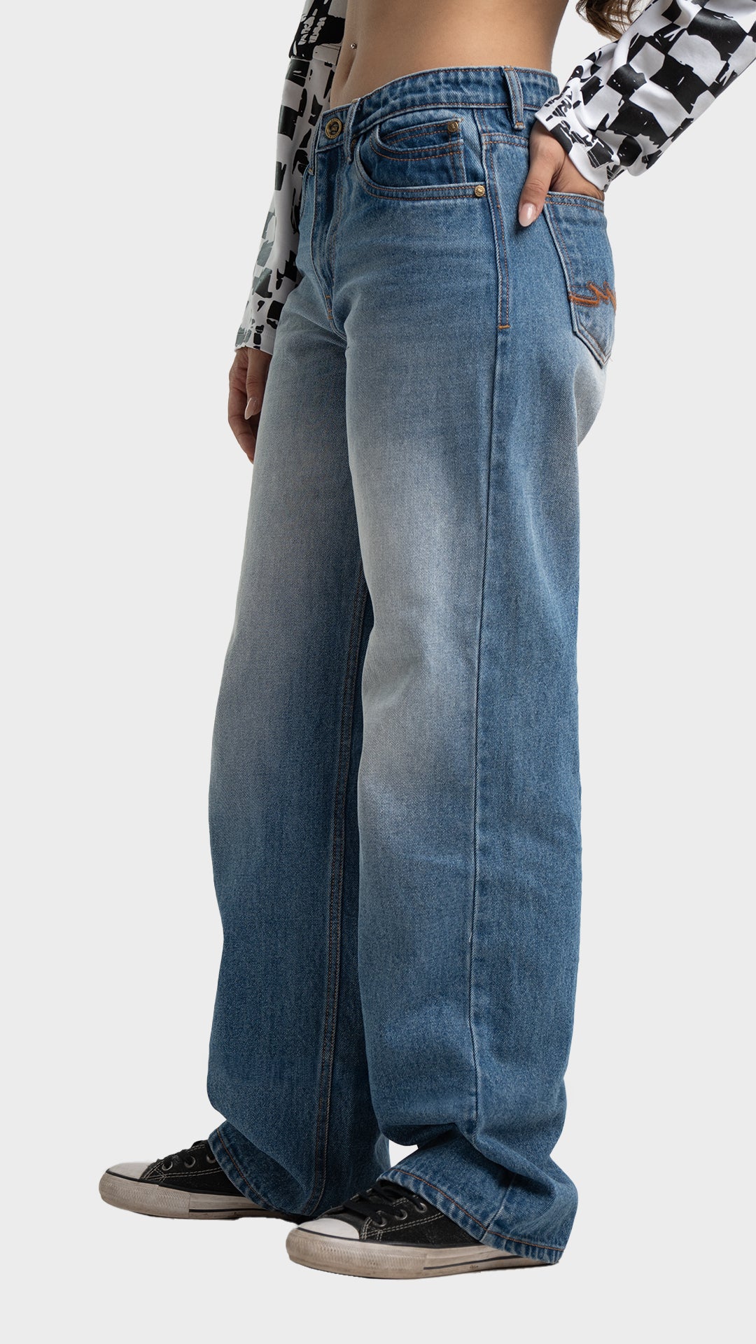 Three-quarter side angle profile of Incroy & Merv women's loose fit nitro blue jeans.