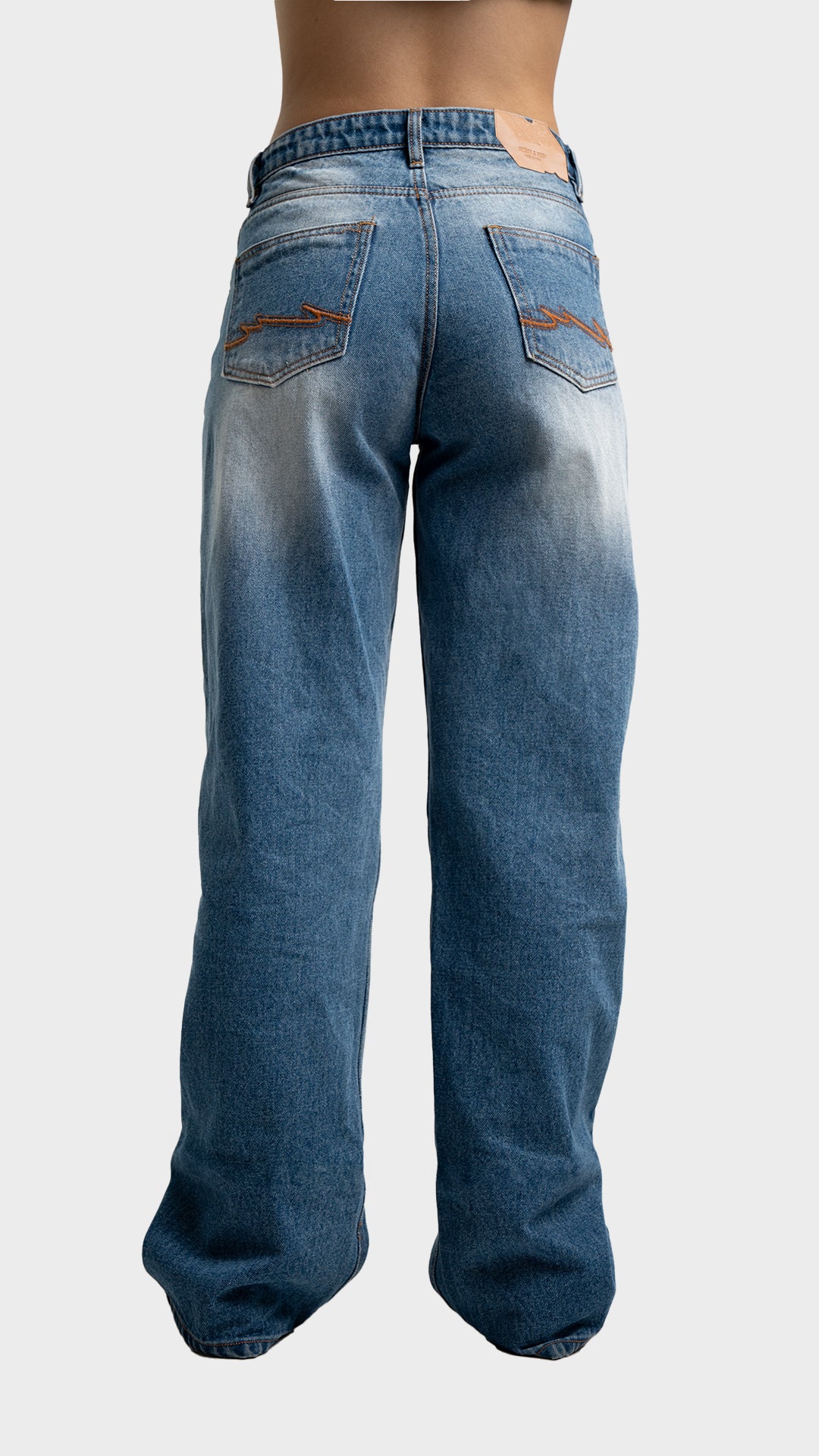 Back pockets and fit perspective of Incroy & Merv women's relaxed fit streetwear jeans in nitro blue.