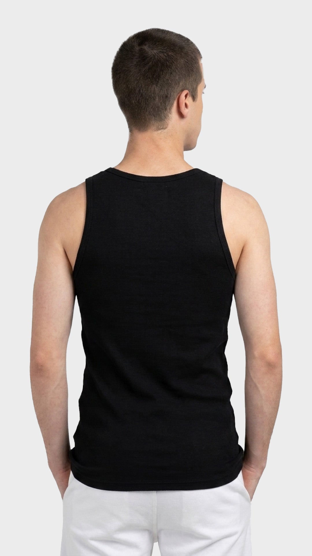 Back view of a men's black ribbed vest.