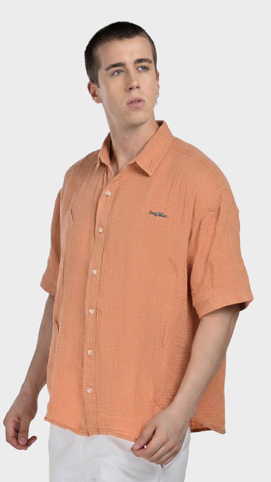 Front view of a men's peach 100% cotton double cloth short sleeve shirt.