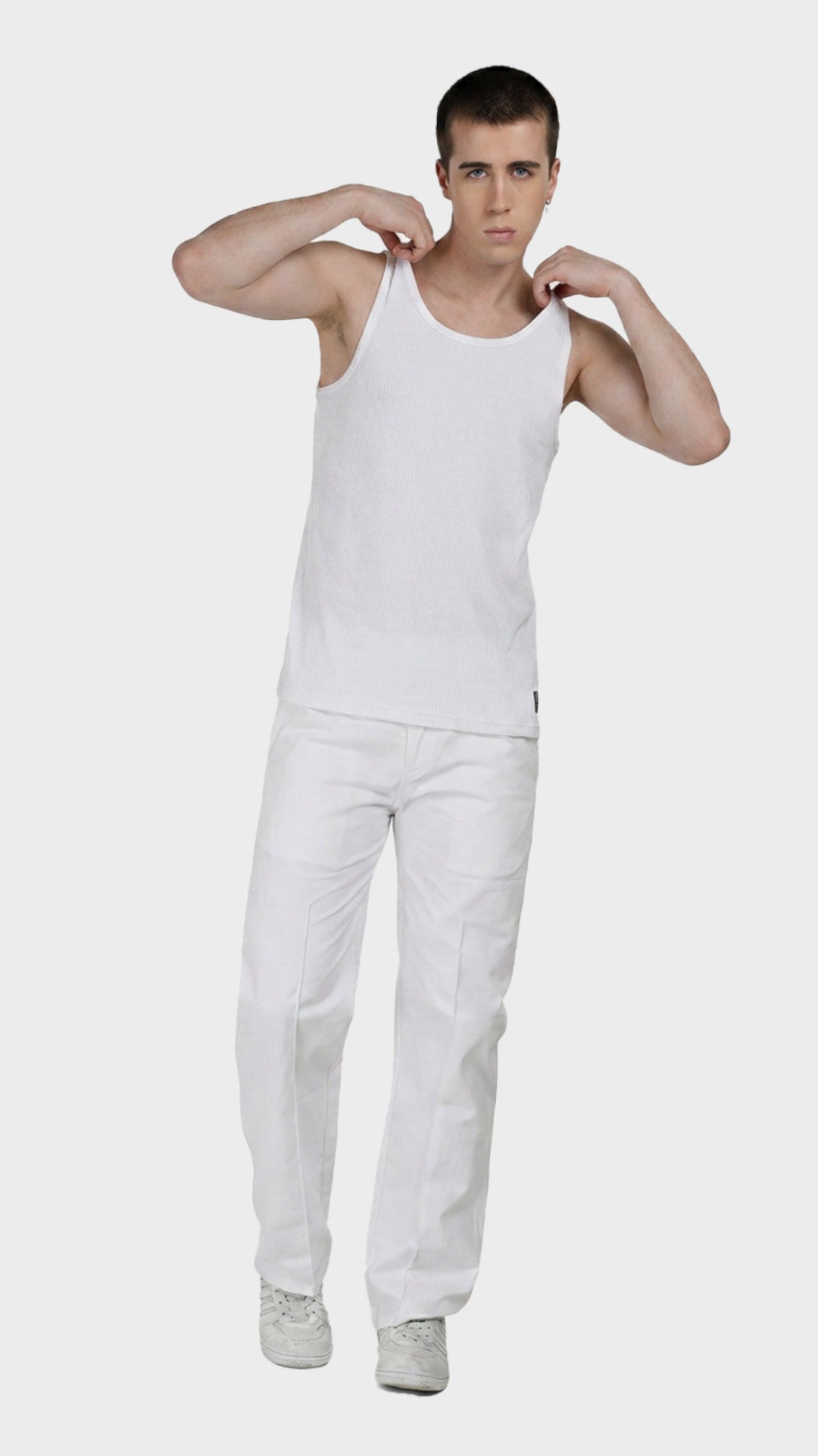 Full-body shot of a male model wearing a white parker fabric vest and trousers.
