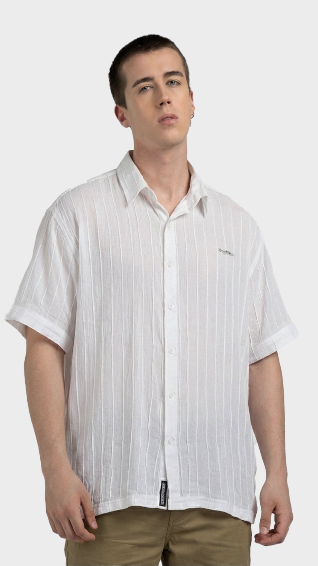 Front view of a male model wearing a white textured rayon crepe short sleeve shirt.