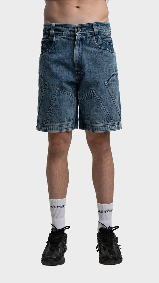Front view of men's blue acid wash denim shorts with geometric panel stitching.