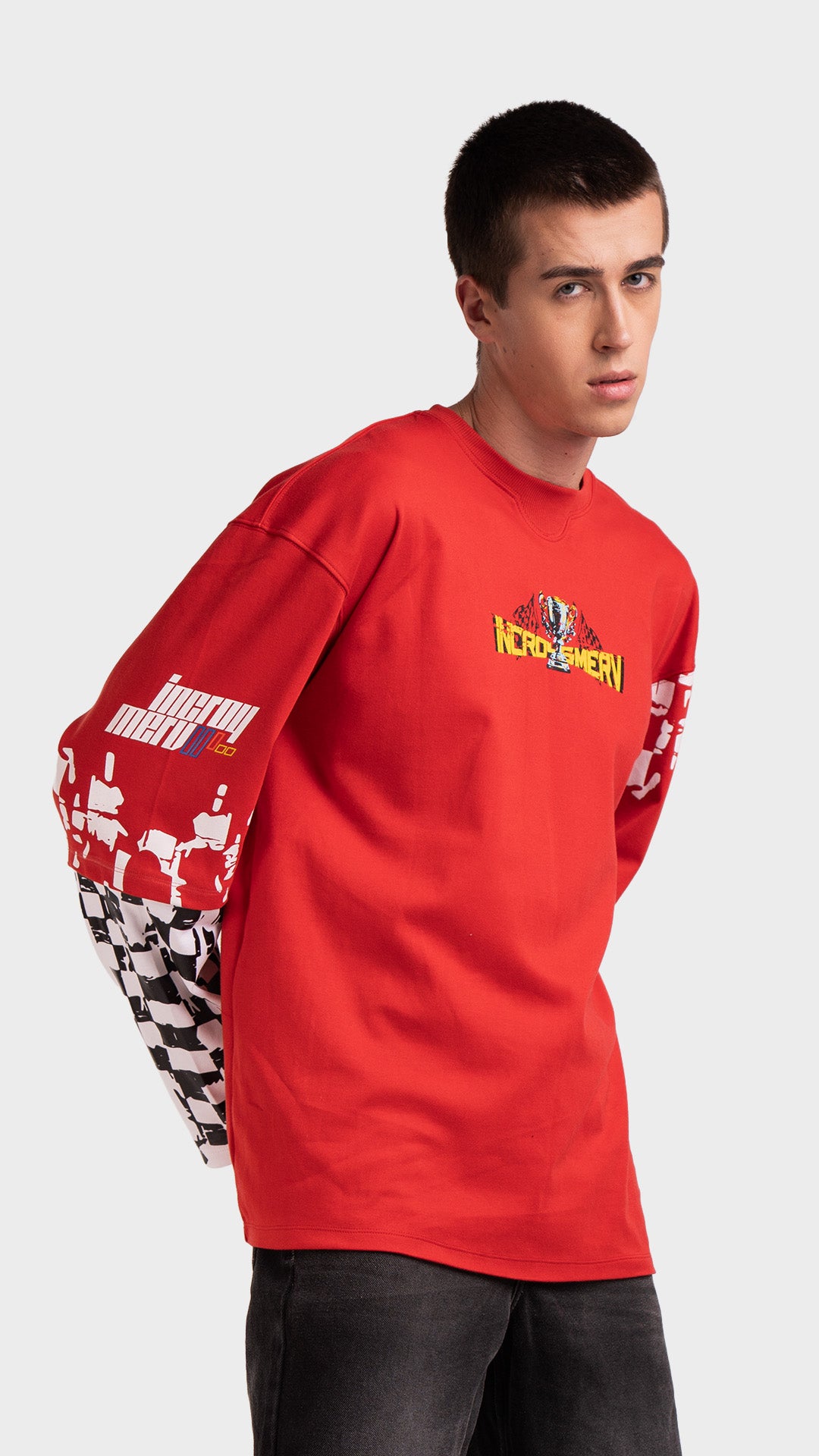 Red layered streetwear shirt with checkered sleeves. Incroy & Merv relaxed fit mediumweight summer tee showing graphic detailing across the arm.
