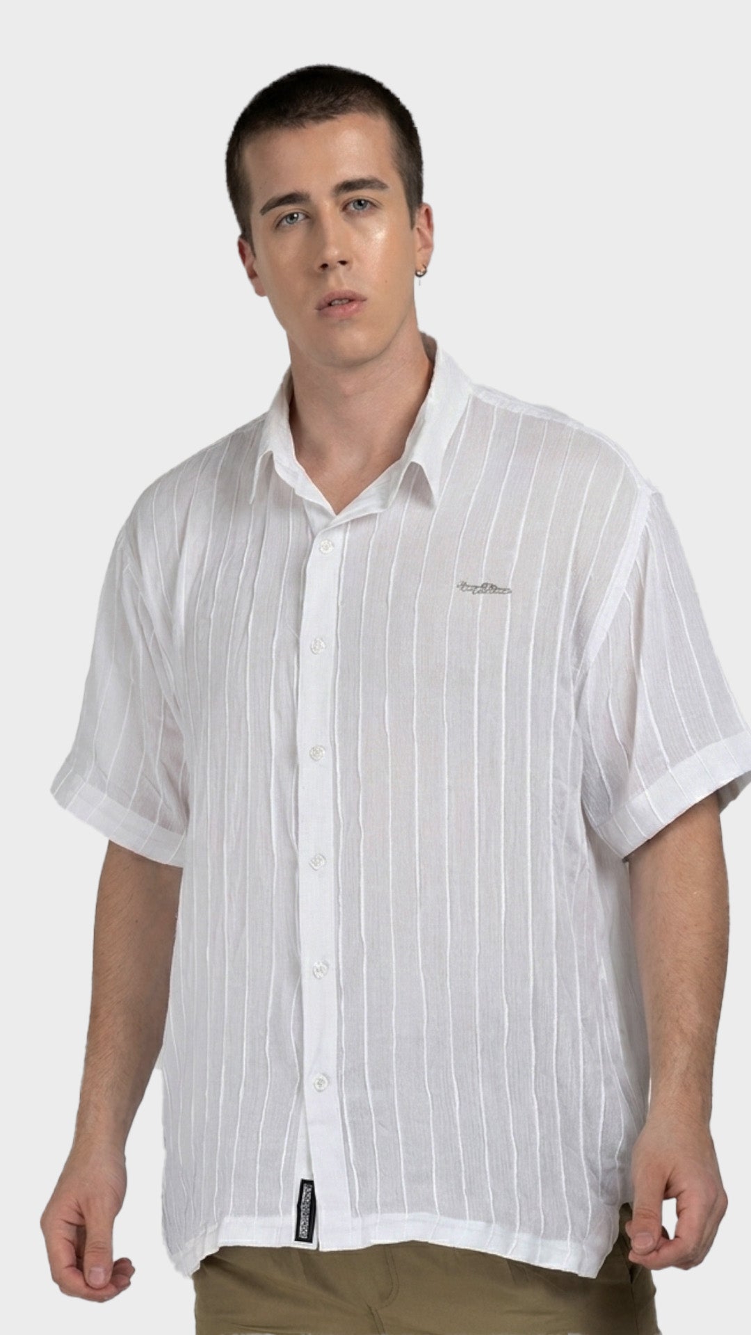 Front view of a white half sleeve rayon crepe shirt with vertical textured stripes.