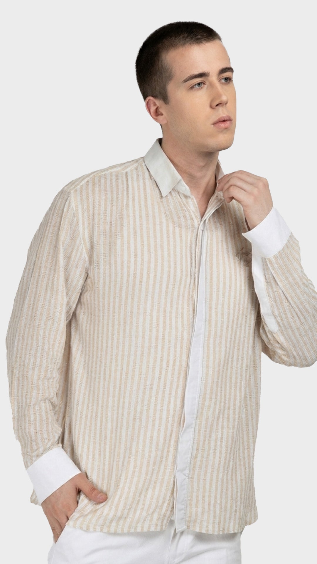 Three-quarter shot showing the relaxed fit of a beige striped dobby casual shirt.