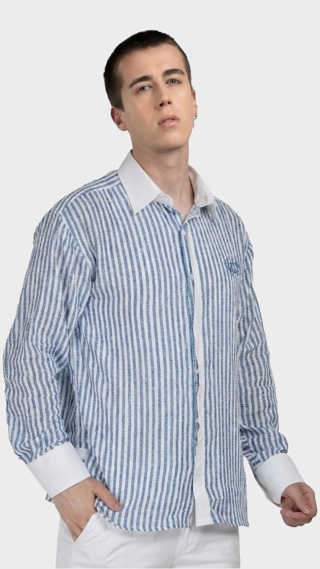 Half-body pose highlighting the textured dobby weave of a blue pinstripe shirt.