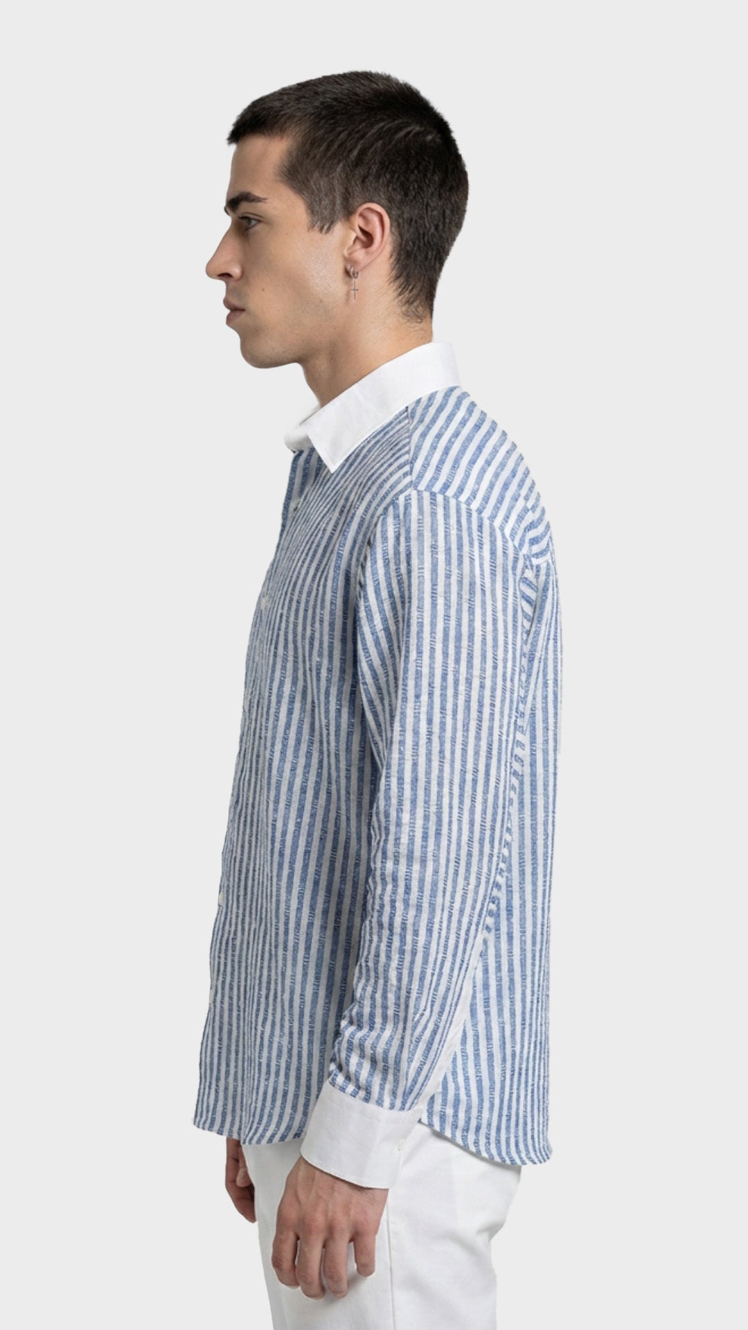Side view of a men's blue pinstripe dobby shirt showing cuff details.
