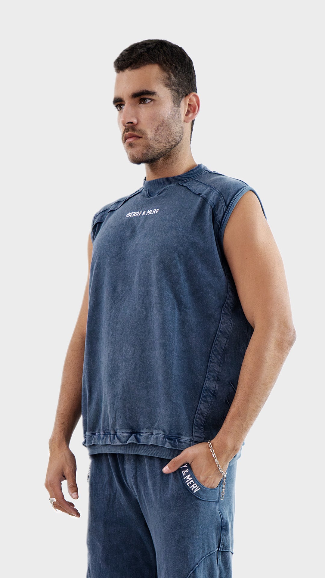 Three quarter side angle view of the Incroy and Merv Dusky Blue Beyond Tank Top highlighting the relaxed sleeveless fit.