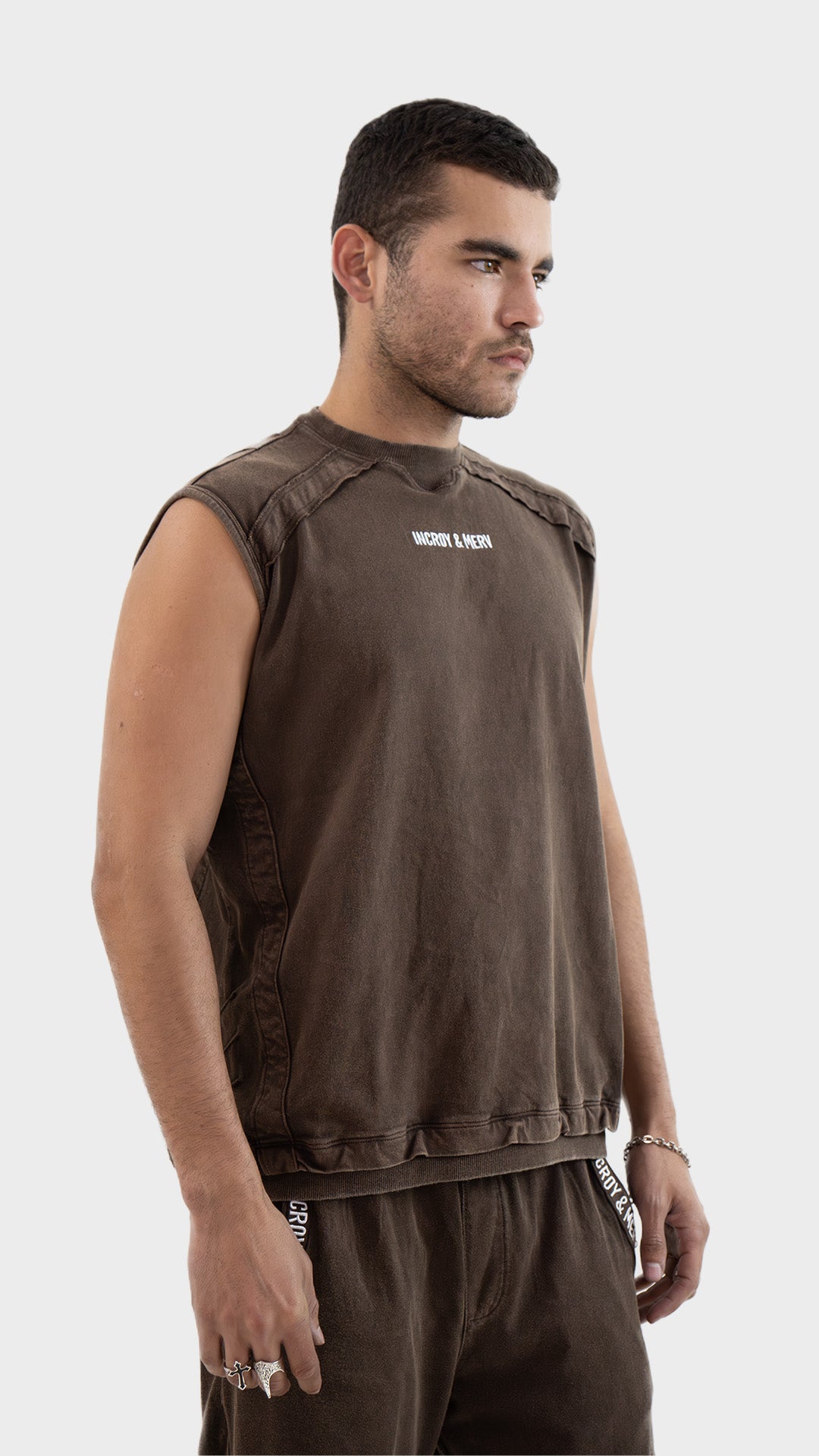 Three quarter angle view of the Incroy and Merv Rustic Brown Beyond Tank Top highlighting the relaxed fit.