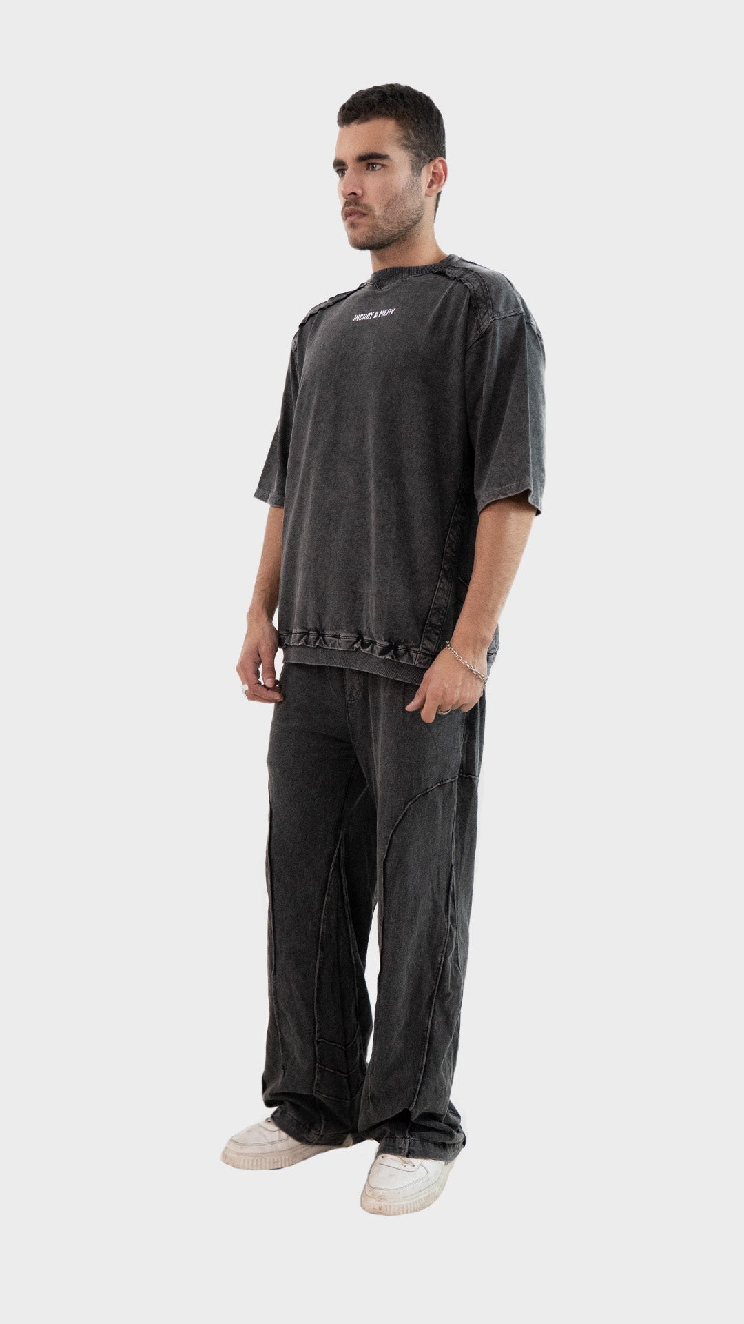 Three quarter angle view of a male model wearing the Incroy and Merv Charcoal Beyond Co-Ord Set.