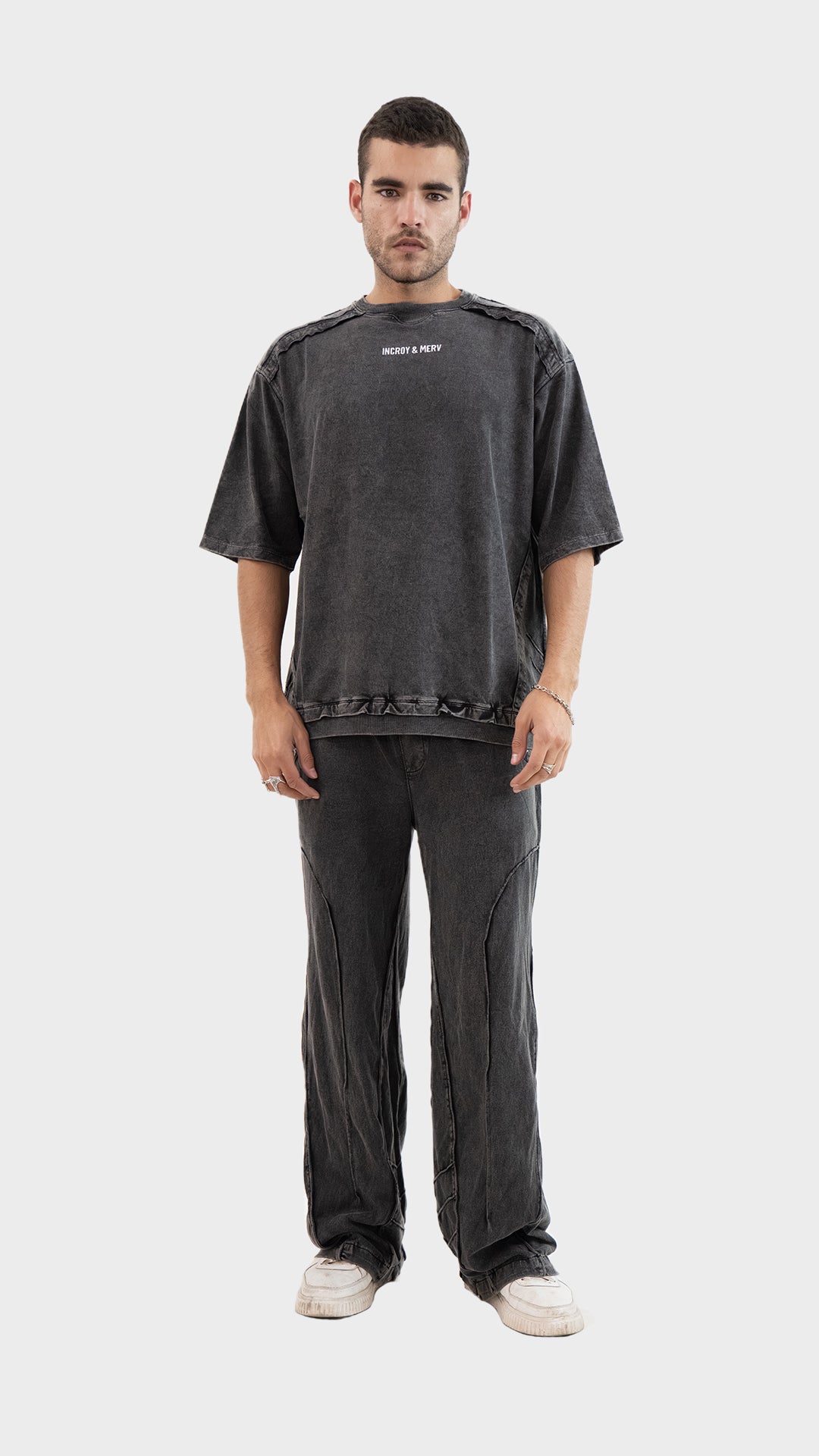 Front view of a man wearing the Incroy and Merv Beyond Co-Ord Set in Charcoal featuring an oversized t-shirt and matching trousers.