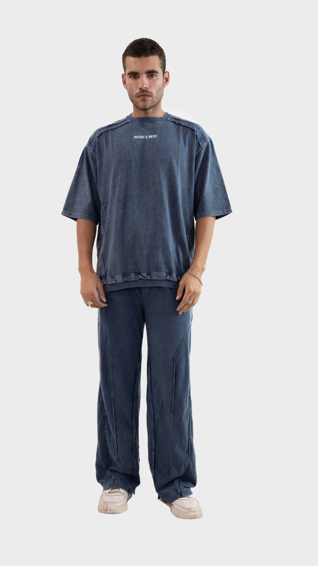 Front view of a man wearing the Incroy and Merv Beyond Co-Ord Set in Dusky Blue featuring an oversized t-shirt and matching trousers.