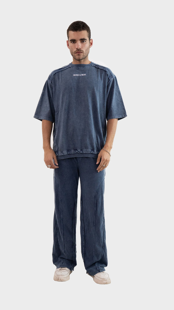 Front view of a man wearing the Incroy and Merv Beyond Co-Ord Set in Dusky Blue featuring an oversized t-shirt and matching trousers.