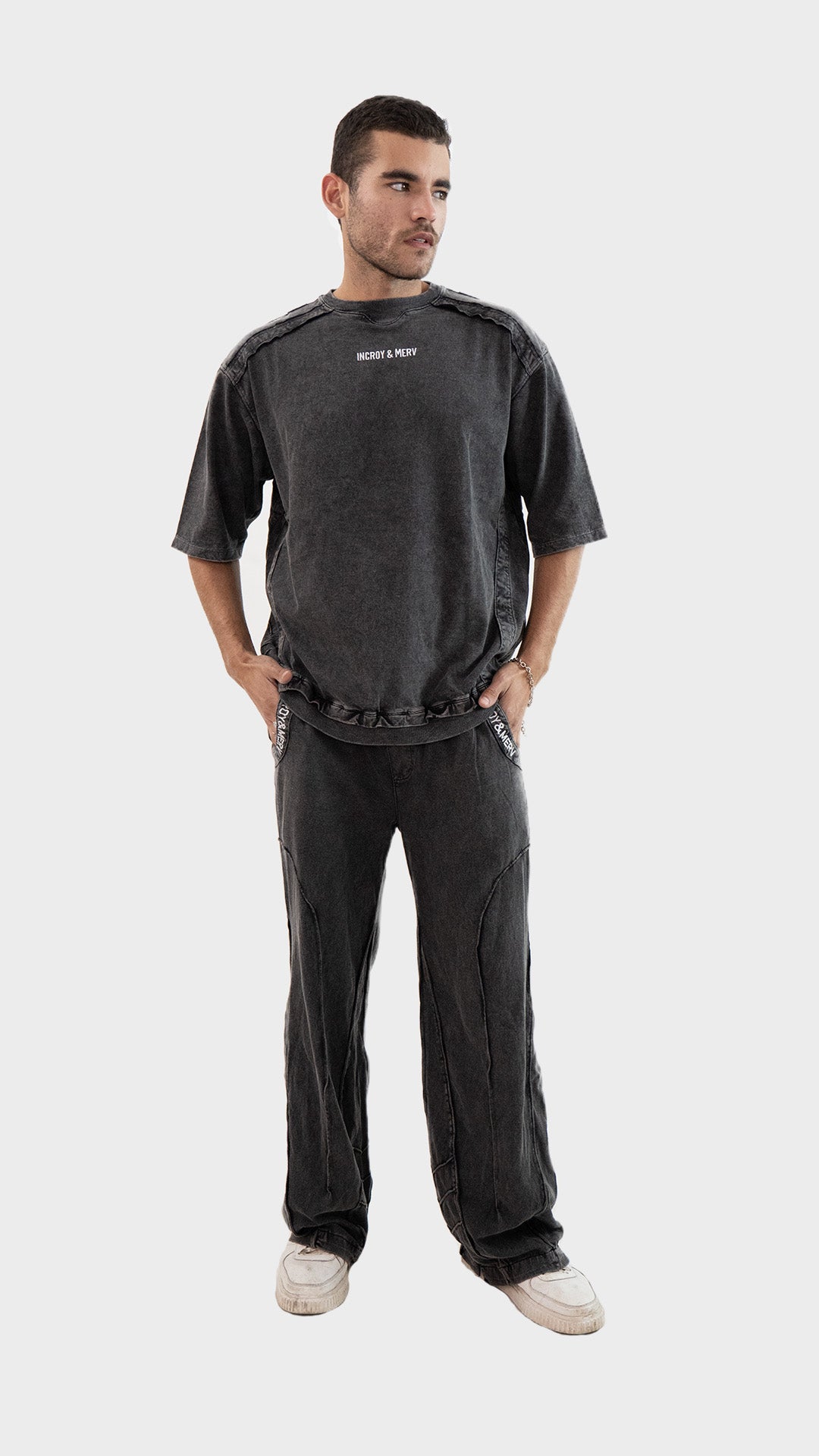 Full body shot of a model wearing the Incroy and Merv Beyond T-Shirt paired with matching charcoal lowers co-ord set.