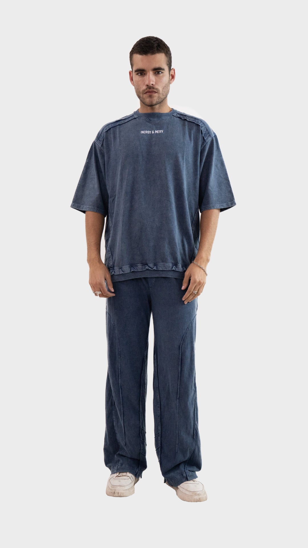 Full length model wearing the Incroy and Merv Beyond T-Shirt paired with matching dusky blue lowers co-ord set.