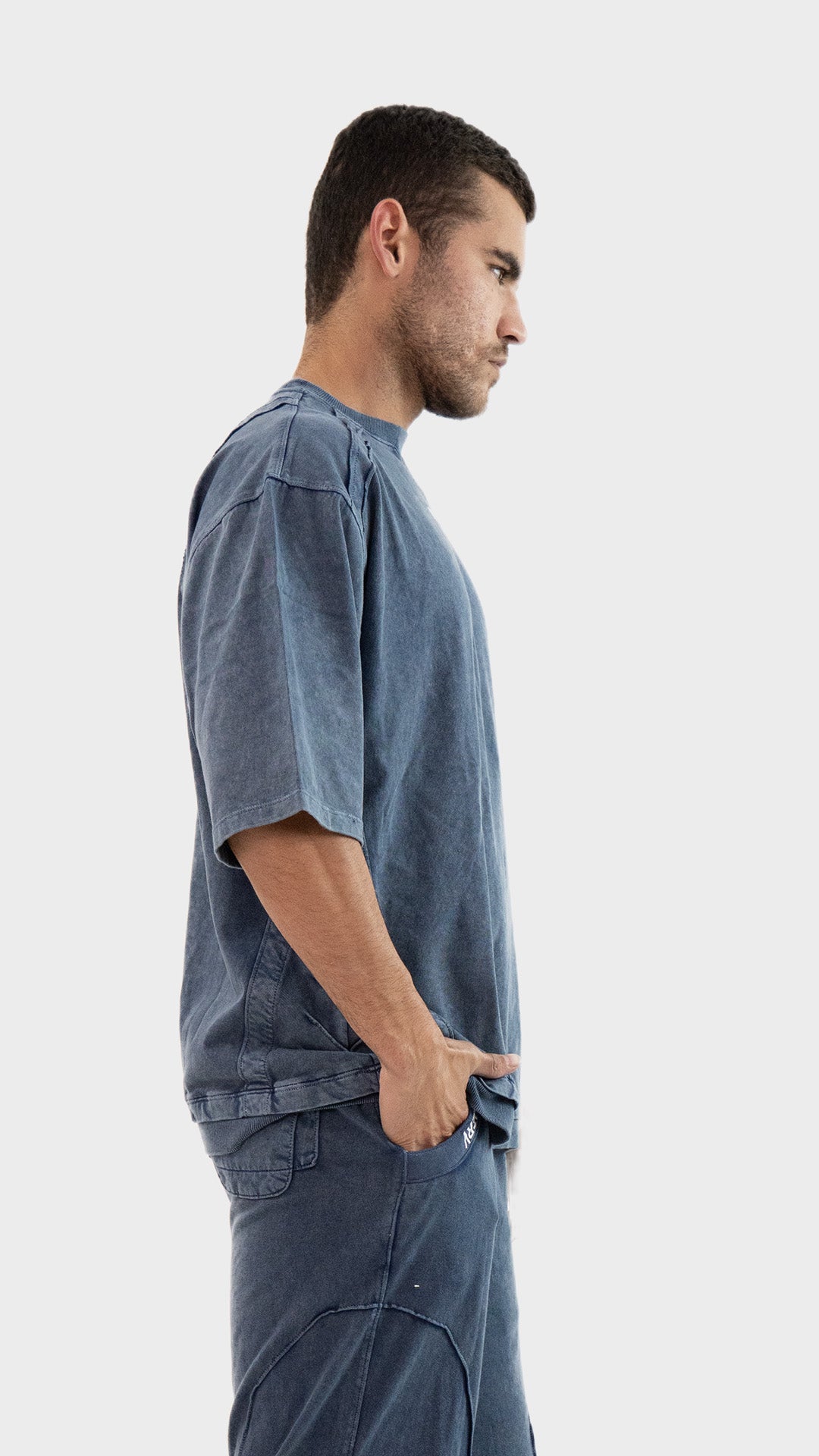 Profile side view of the Incroy and Merv Beyond T-Shirt in Dusky Blue highlighting the streetwear silhouette.