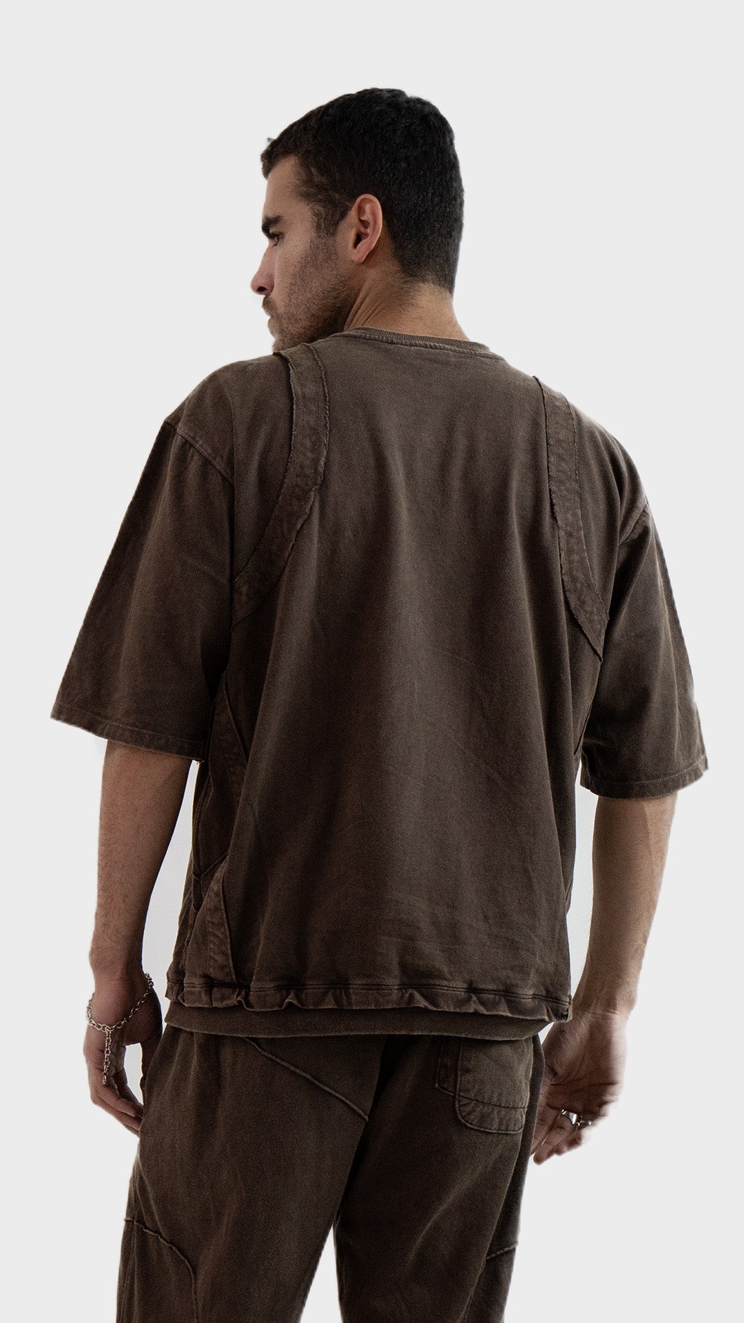Back view of the Incroy and Merv Rustic Brown Beyond T-Shirt showcasing a washed vintage finish and seam detailing.