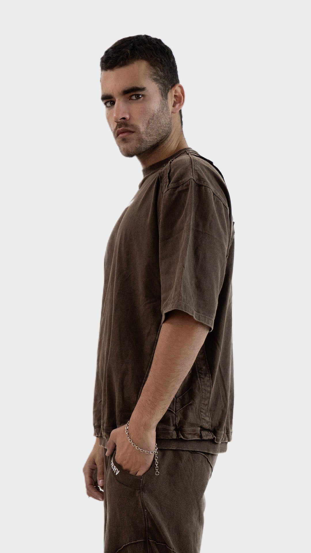 Profile side angle of the Incroy and Merv Beyond T-Shirt in Rustic Brown highlighting the relaxed drop shoulder fit.
