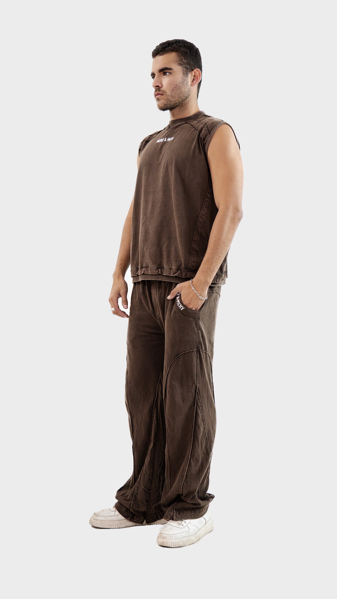 Three quarter angle view of a male model wearing the Incroy and Merv Brown Beyond Tank Top Co-Ord Set.
