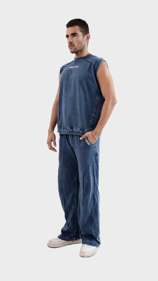 Three quarter angle view of a male model wearing the Incroy and Merv Dusky Blue Beyond Tank Top Co-Ord Set.