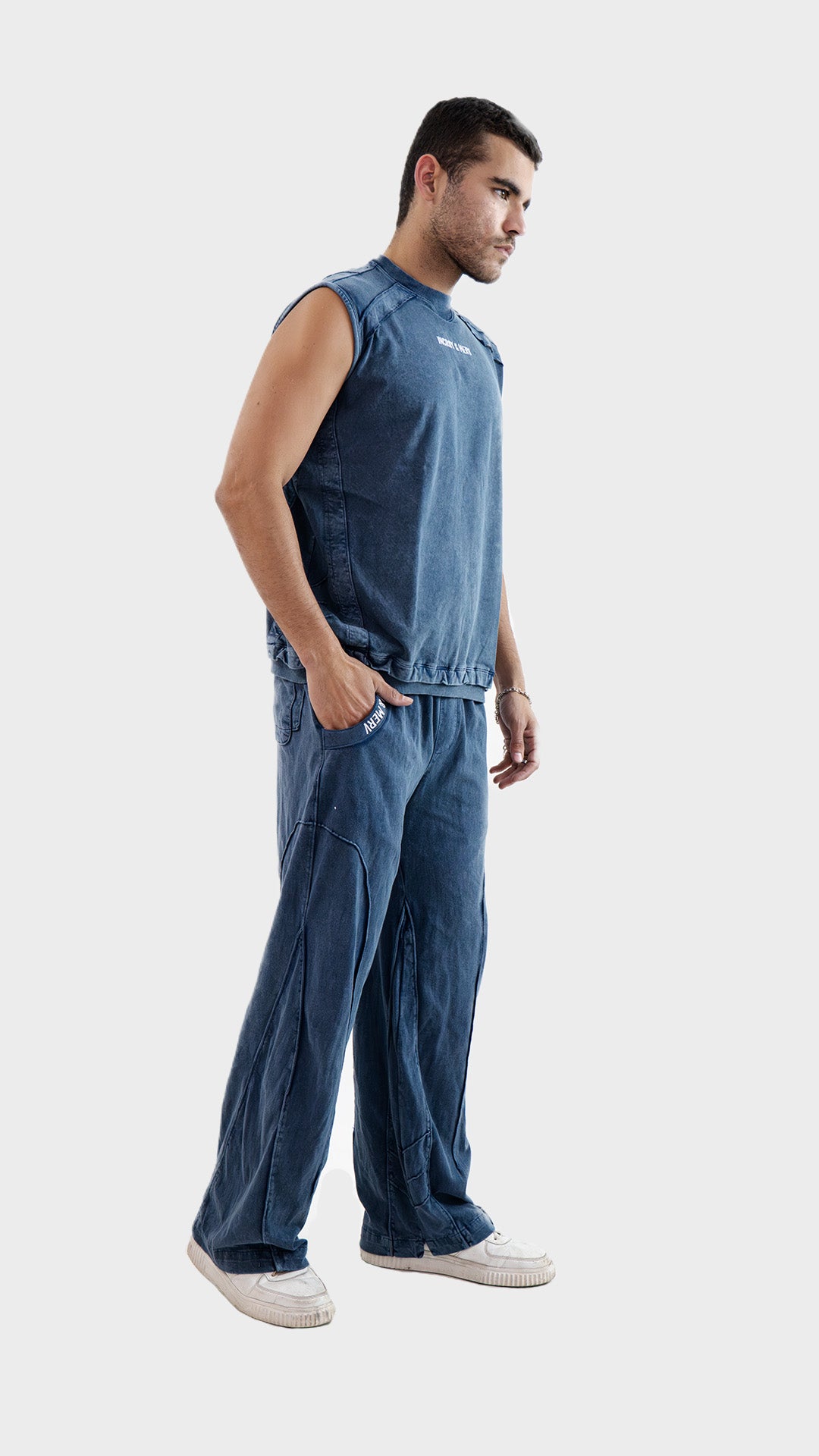 Side profile view of the Incroy and Merv Beyond Tank Top Co-Ord Set in Dusky Blue showcasing sleeveless streetwear style.