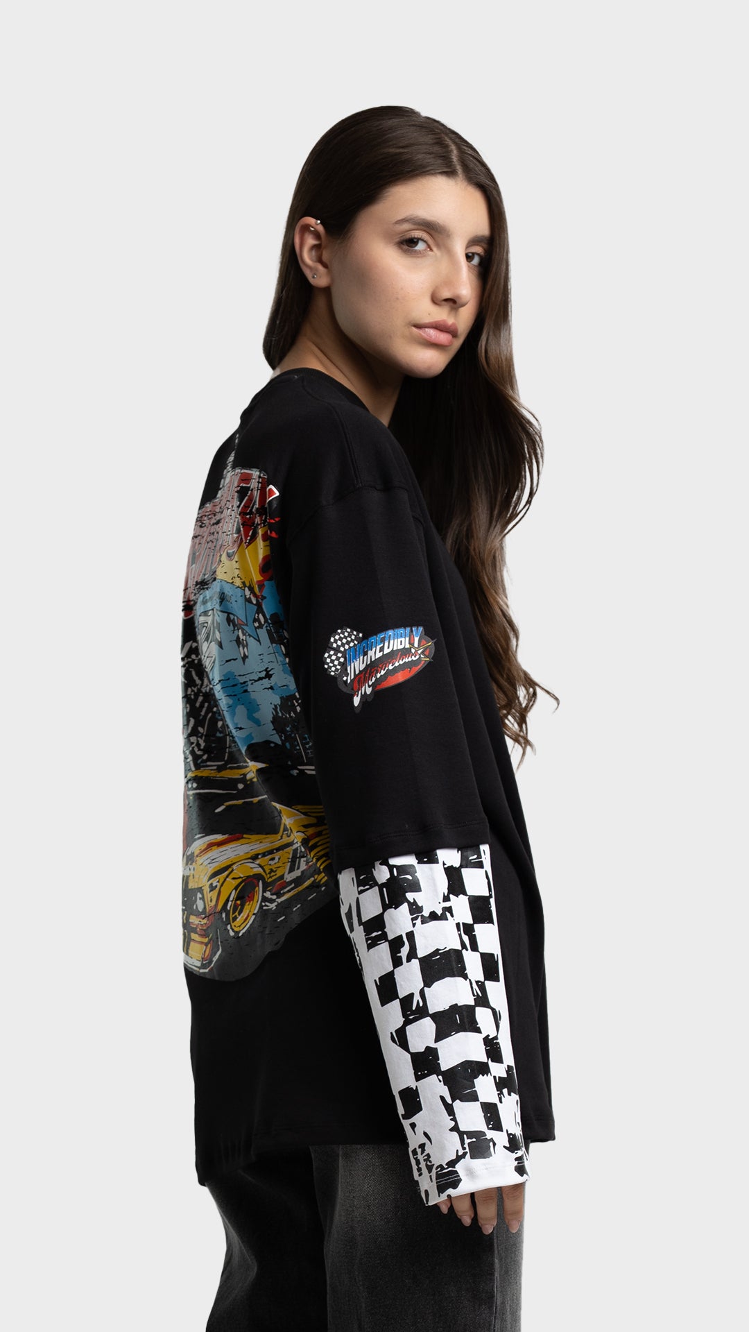 Side view of Incroy & Merv black oversized racing graphic tee showing sleeve details.