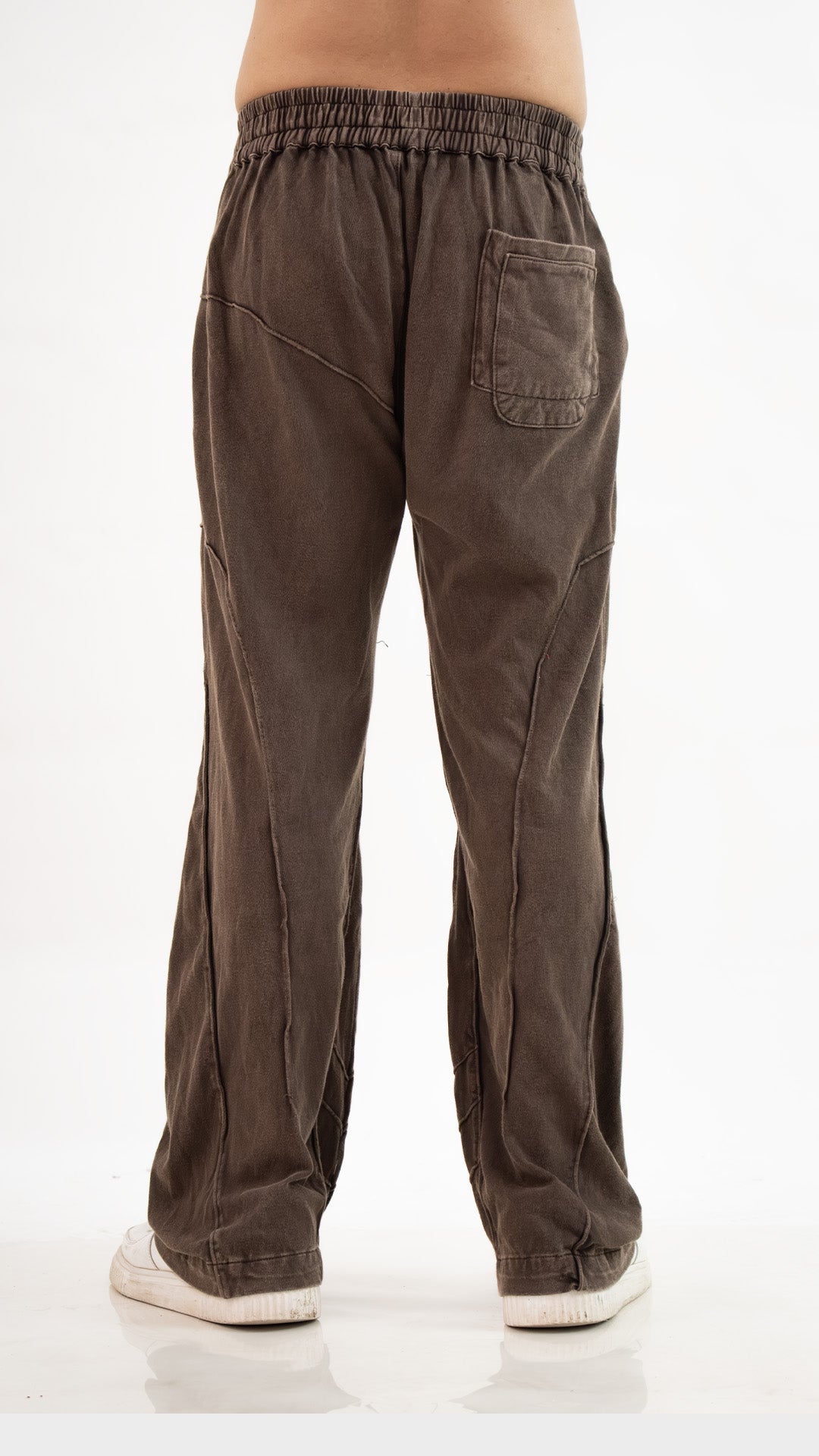 Back view of Incroy & Merv men's Beyond Trouser in brown cotton sinker fabric showing panel stitching and rear pocket.