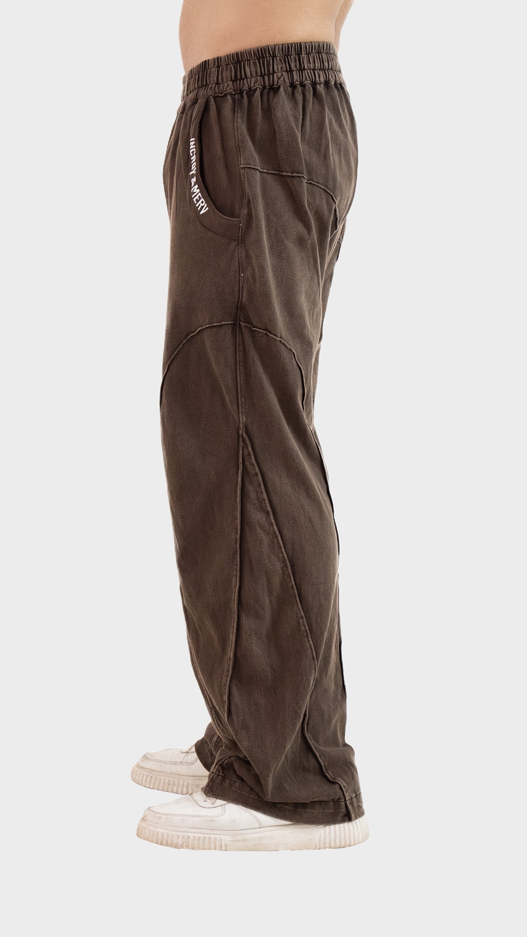 Side profile view showing the straight-leg relaxed fit and seam detail of Incroy & Merv men's brown Beyond Trouser.