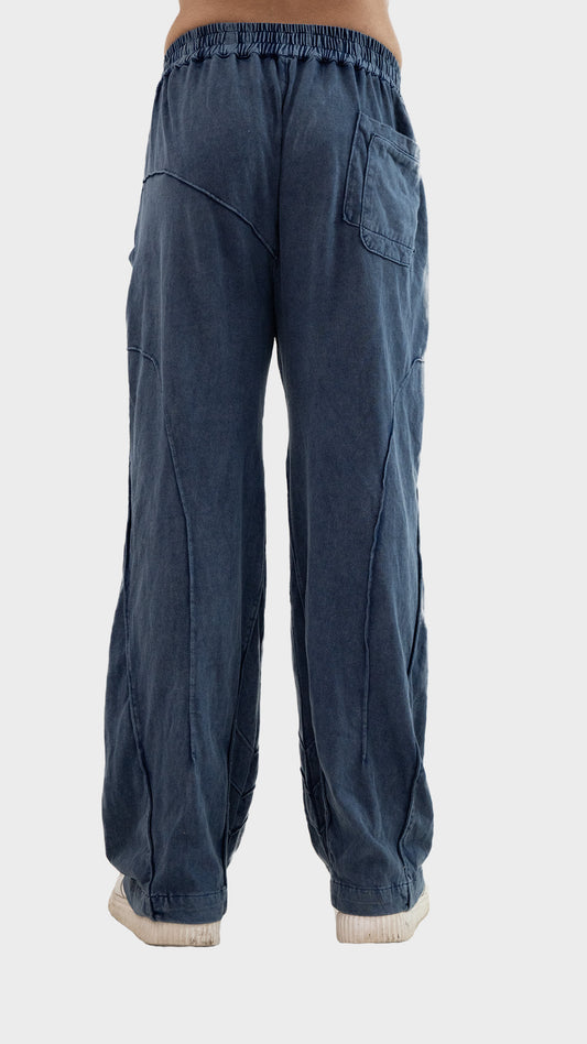 Back view of Incroy & Merv men's Beyond Trouser in dusky blue cotton sinker fabric with back pocket and seam paneling.