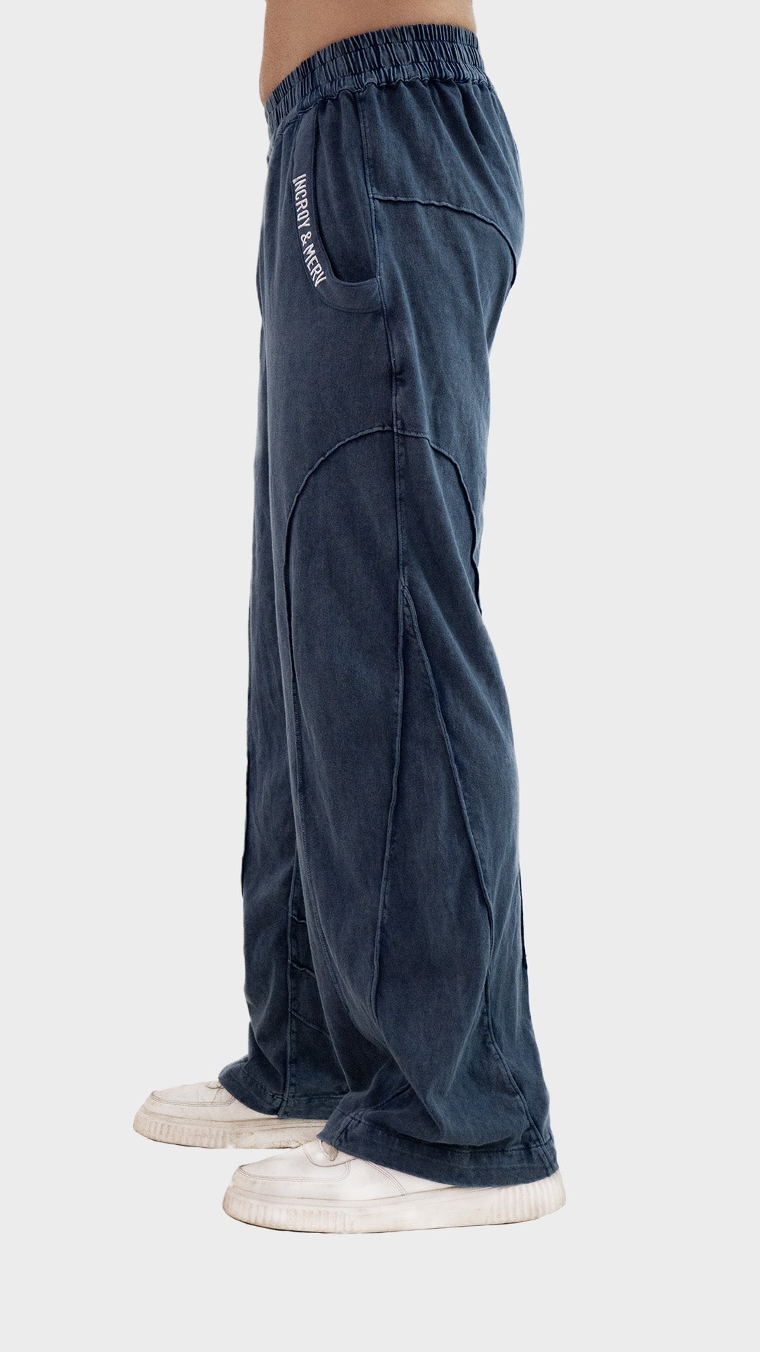 Side profile view showing the relaxed straight-leg fit and seam structure of Incroy & Merv men's dusky blue Beyond Trouser.