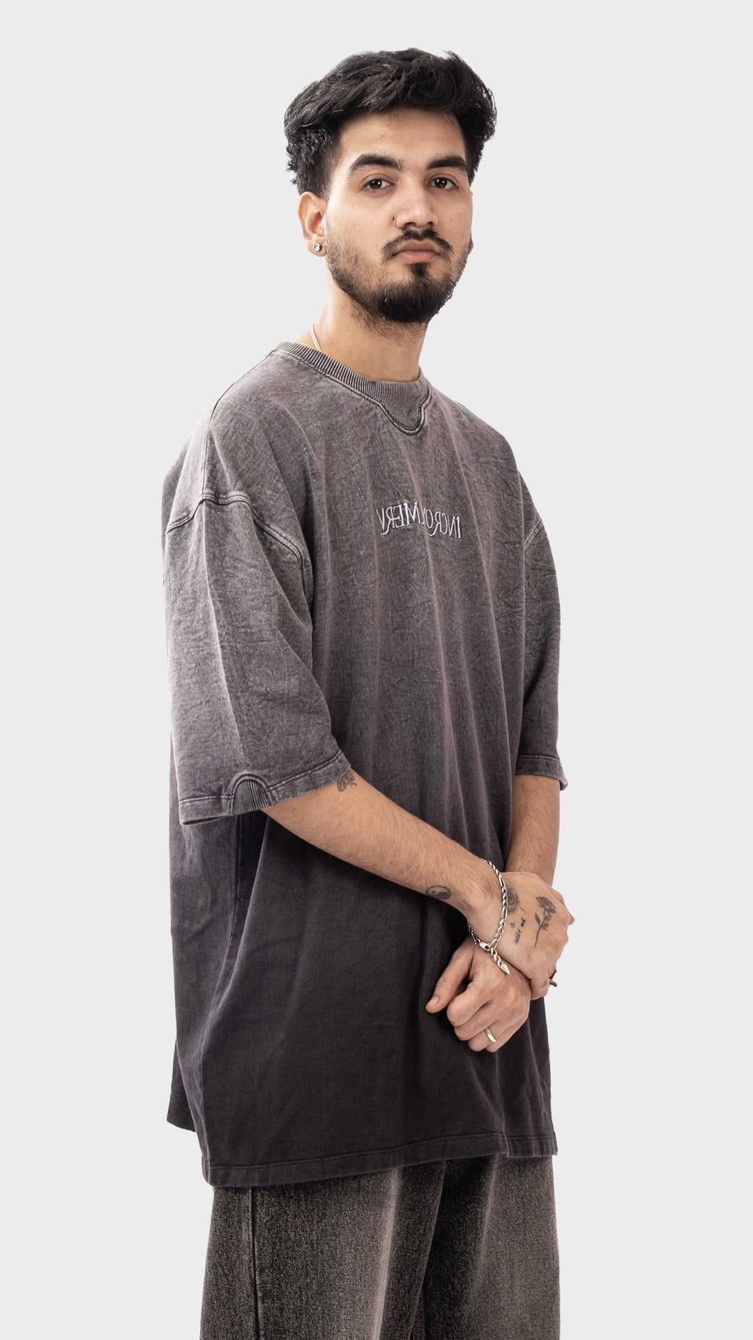 Three-quarter studio view of men's drop shoulder streetwear tee in vanished charcoal by Incroy & Merv.
