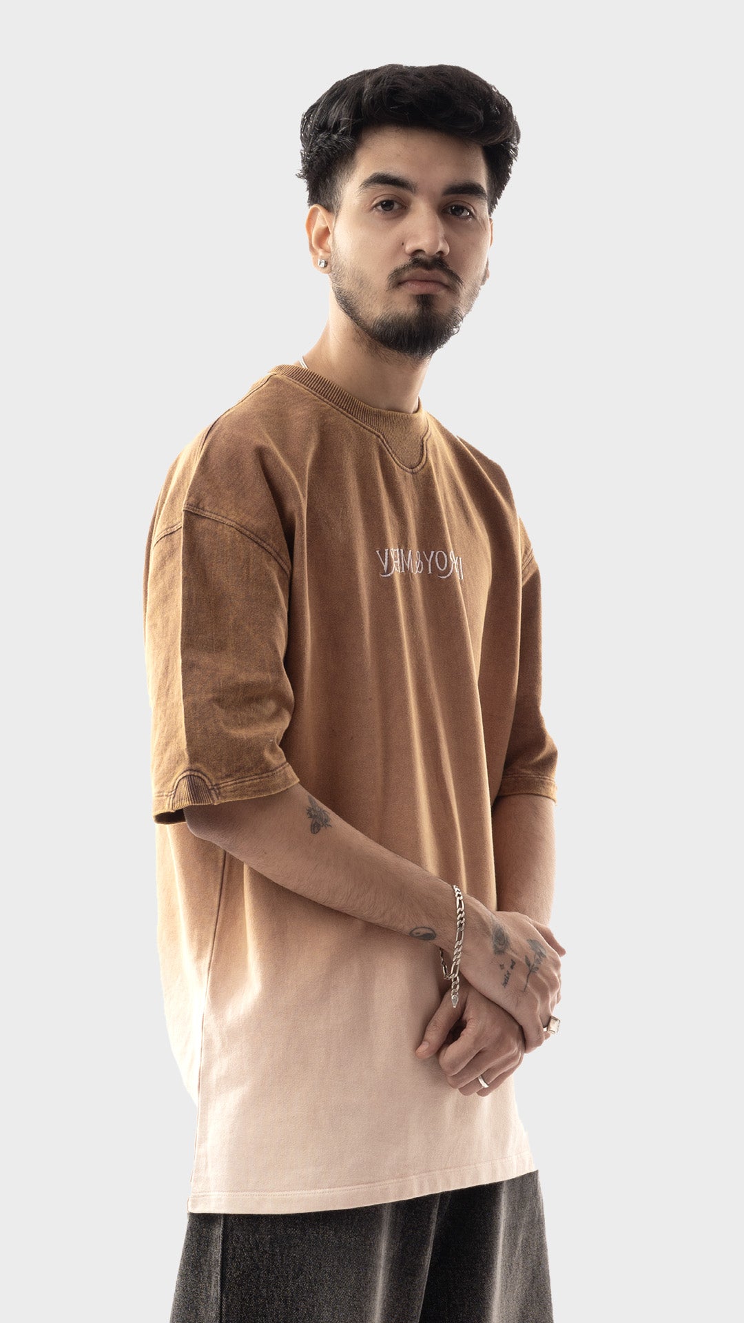 Three-quarter studio view of men's drop shoulder streetwear tee in vanished dust by Incroy & Merv.