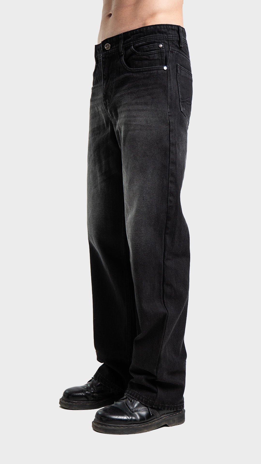 Side angle profile of Incroy & Merv men's loose fit washed black jeans.