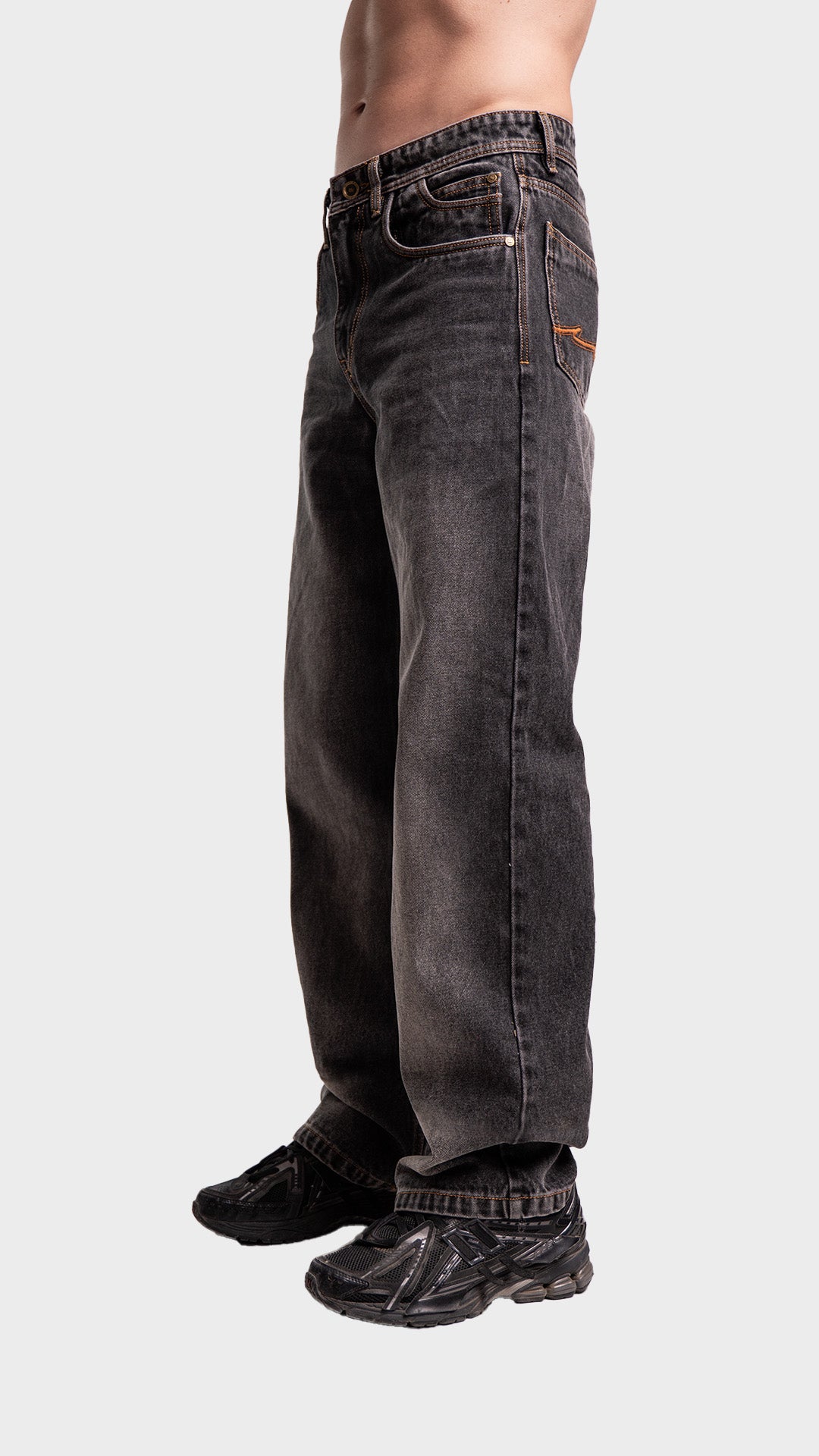 Side angle profile of Incroy & Merv men's loose fit smoked grey jeans.