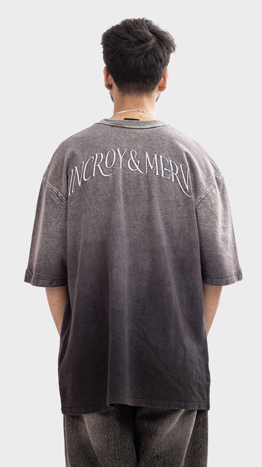 Back embroidery detail on Incroy & Merv men's loose fit faded charcoal t-shirt.