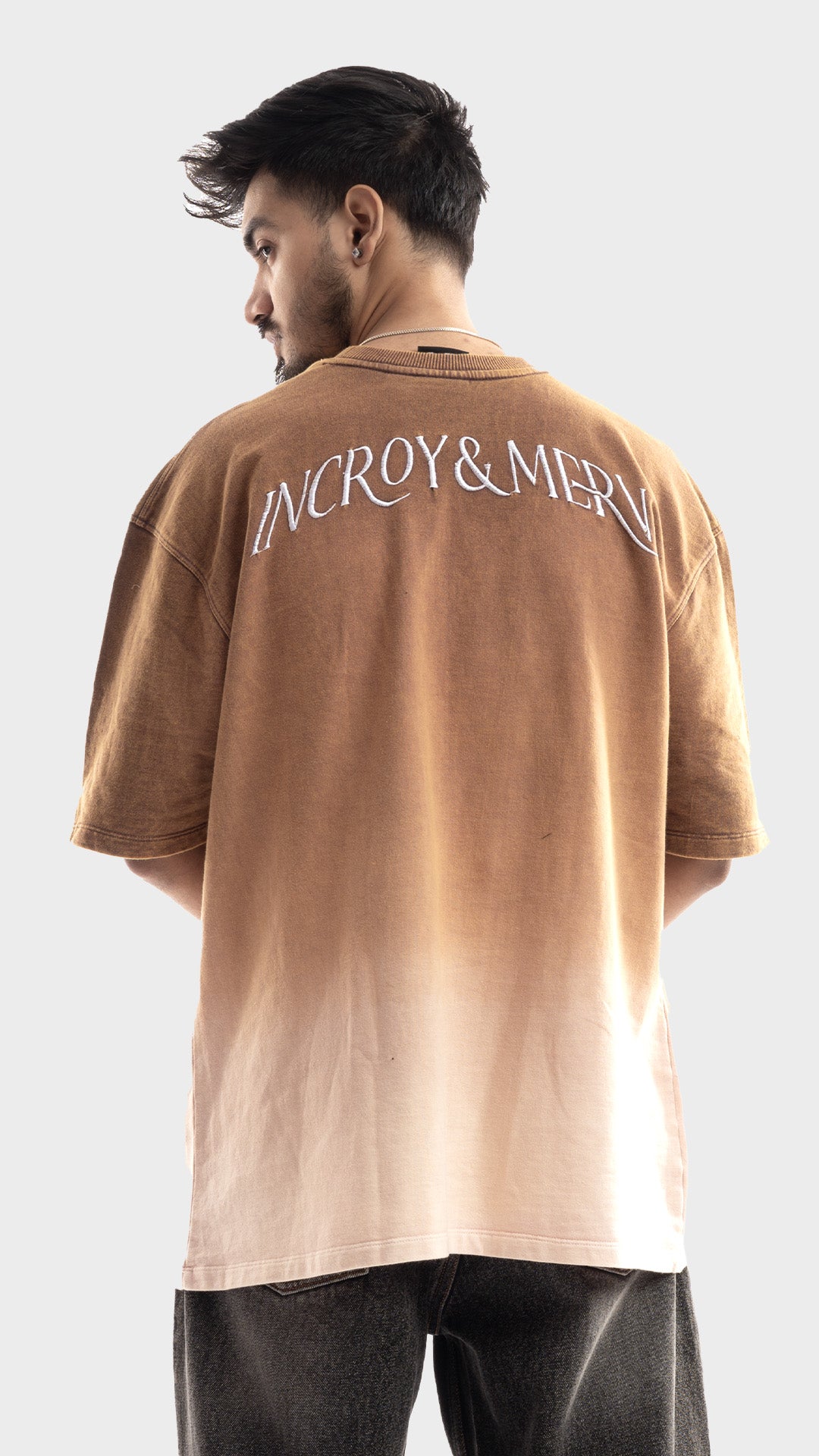 Faded brown back graphic embroidery on Incroy & Merv men's loose fit vanished dust tee.