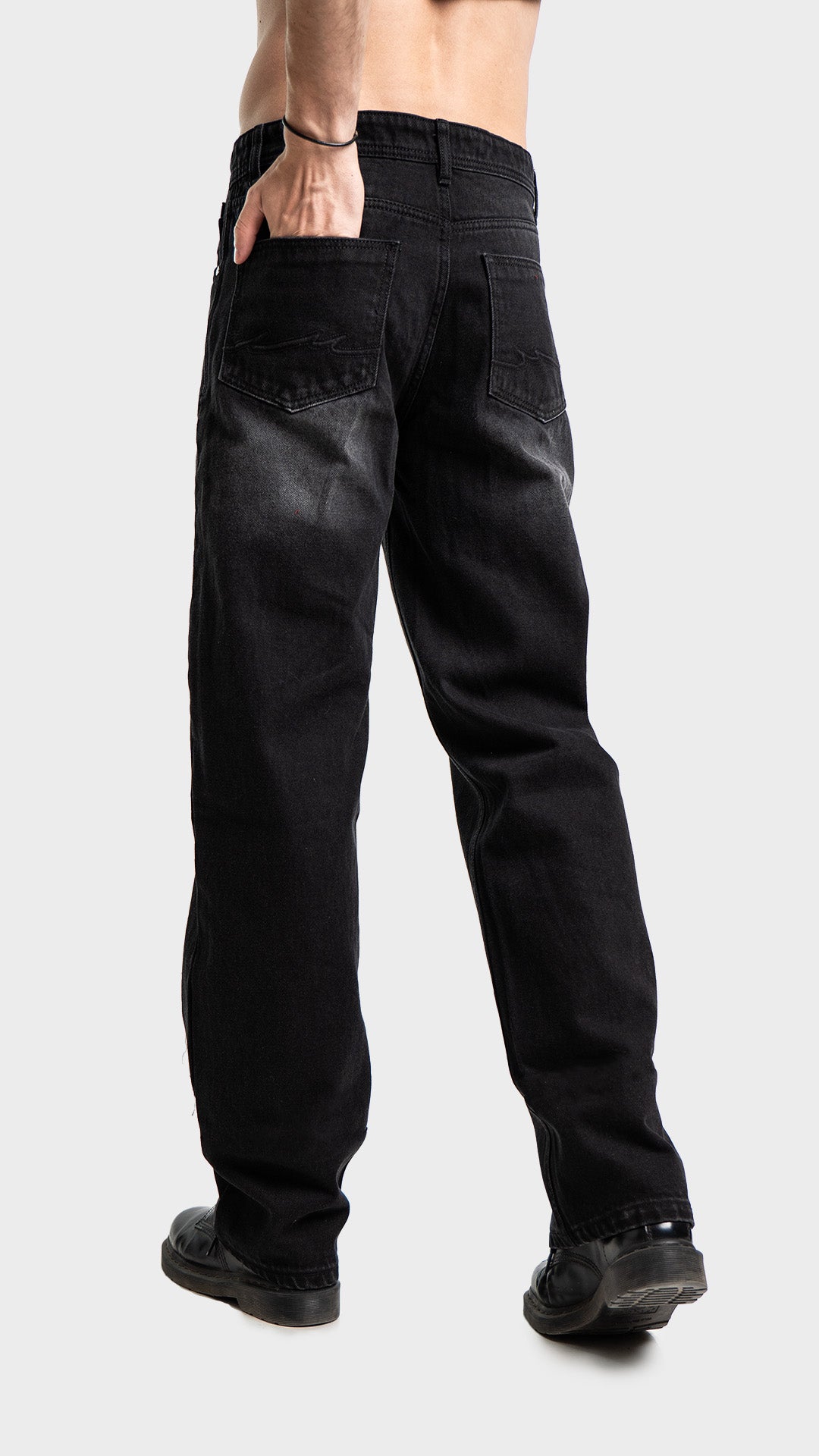 Full body back perspective of Incroy & Merv men's washed black baggy jeans.